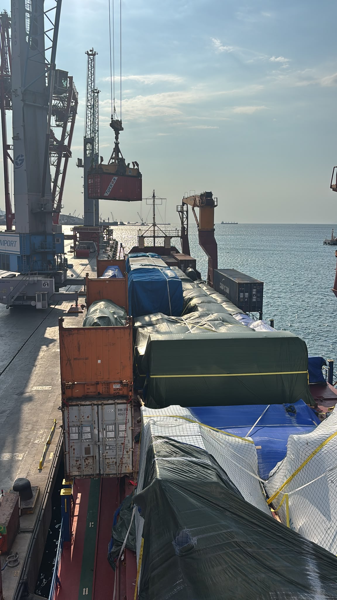 Ship deck with containers and cranes