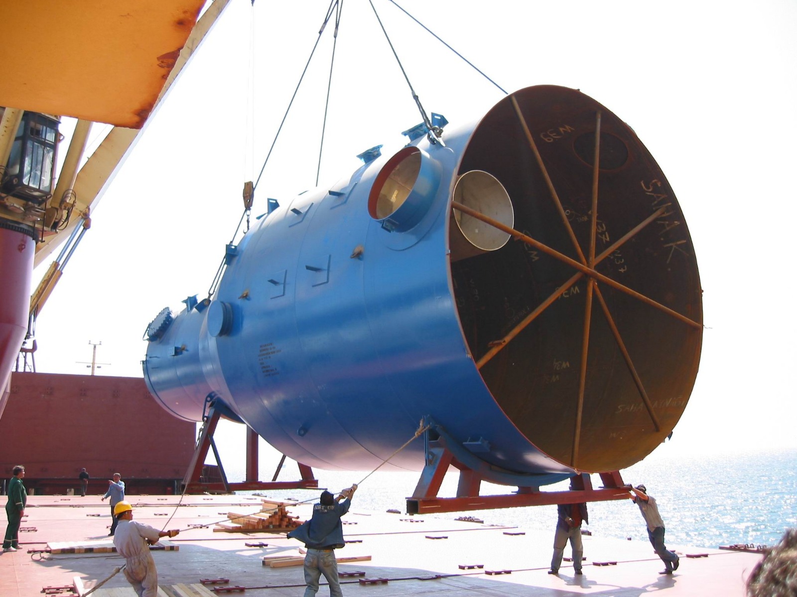 Industrial reactor being crane-lifted onto ship