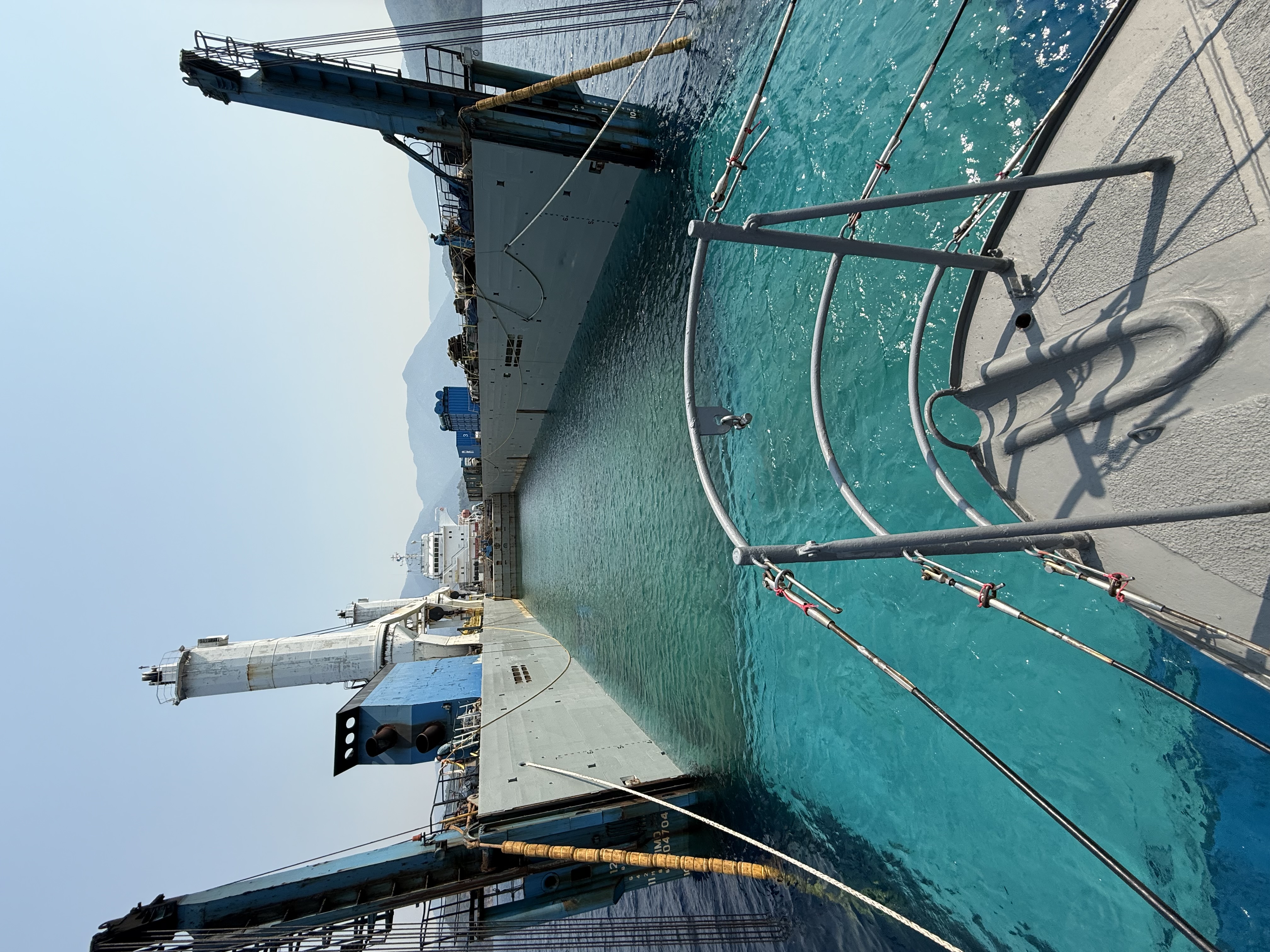 Turquoise water between vessel hulls